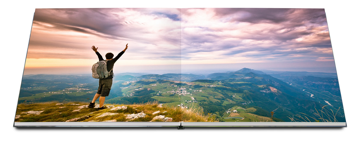 Photo book with Layflat binding and climber in front of landscape.
